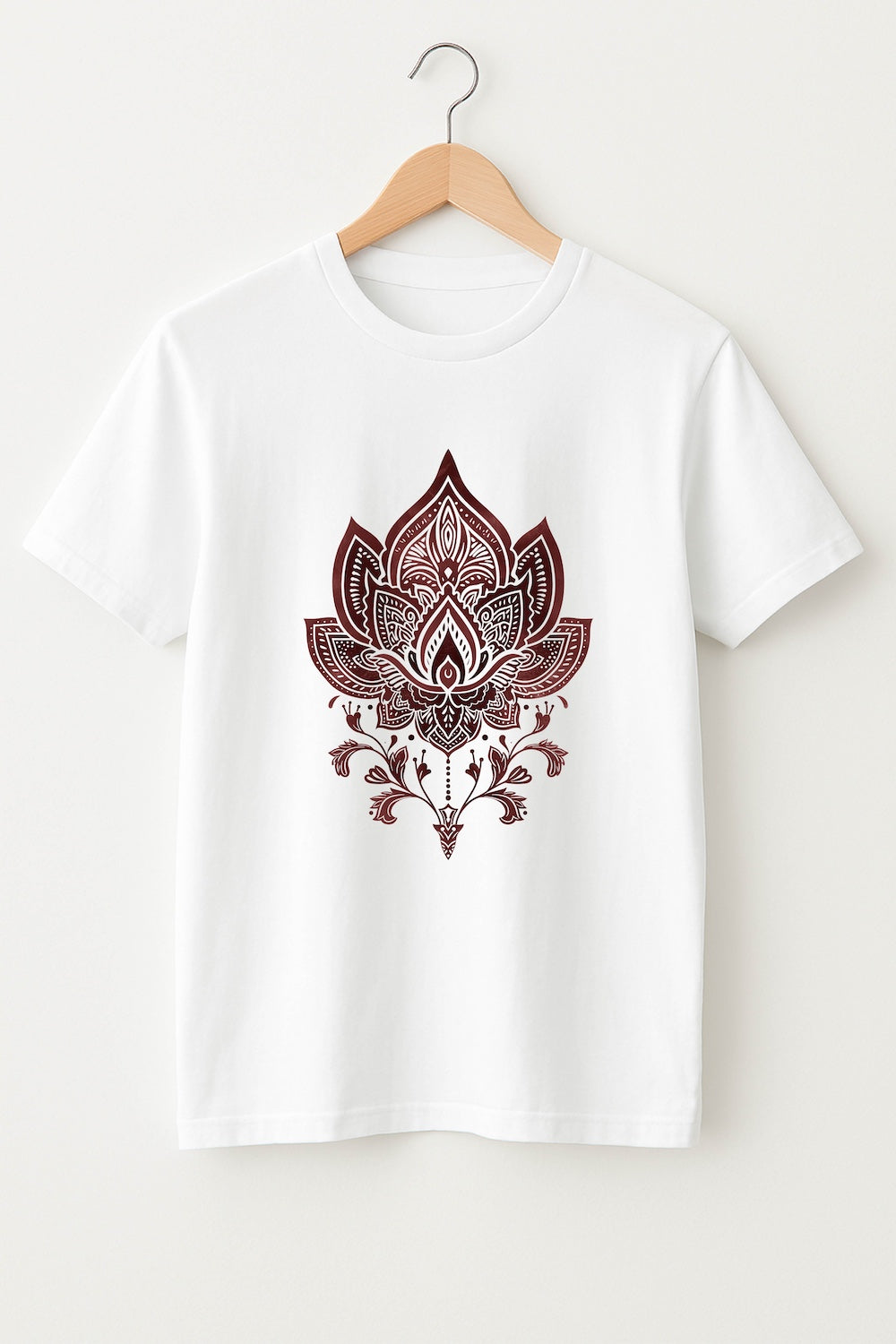 White t-shirt with a brown maroon lotus flower design on a hanger against a white background